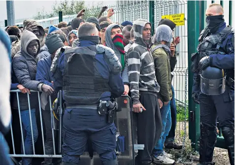  ??  ?? Hopeful migrants queuing yesterday outside the enclosure where British officials process the claims of unaccompan­ied minors seeking refugee status and residency in the UK