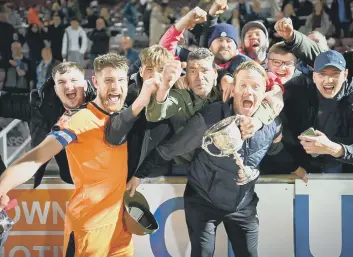  ?? ?? Sports bossJimmy Dean (right) and skipper Richard Jones celebrate a cup final success. Photo: James Richardson.