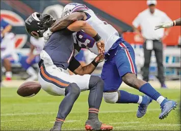  ?? Jonathan Daniel / Getty Images ?? Buffalo’s Andre Smith separates Bears rookie QB Justin Fields from the ball during the Bills’ 41-15 win. Smith was flagged for a 15-yard roughing-the-passer personal foul on the play.
