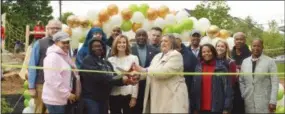  ?? SUBMITTED PHOTO ?? Local officials and community members cut the ribbon to celebrate the new nature and water playground at Palmer Park in Coatesvill­e.