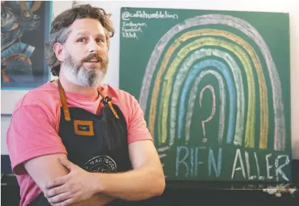  ?? ALLEN MCINNIS ?? “We’re in survival mode, and it’s been that way since March 14,” says Jason Malo, co-owner of Humble Lion coffee shop and another downtown café. The question mark on the chalkboard rainbow sign at Humble Lion says it all.