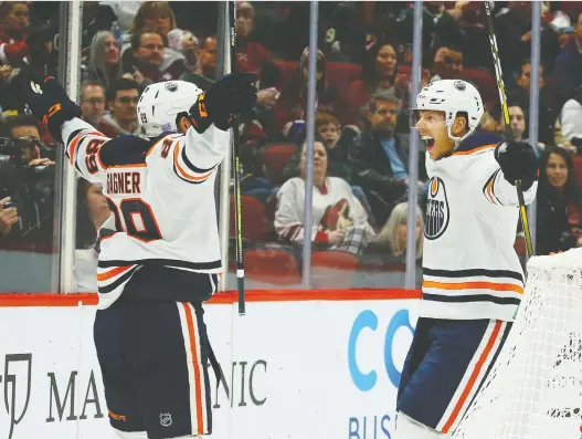  ?? ROSS D. FRANKLIN/THE ASSOCIATED PRESS ?? Oilers right-winger Alex Chiasson celebrates his goal against the Arizona Coyotes with centre Sam Gagner during Sunday’s 4-3 shootout victory.