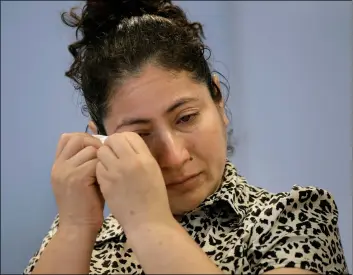  ?? AP PHOTO/STEVEN SENNE ?? A mother from Guatemala, identified only by initials L.J., who was separated from her two children after entering the U.S. in May of 2018, is tearful while speaking to reporters about the separation during a news conference.