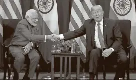  ?? Andrew Harnik / AP ?? President Donald Trump, right, and Indian Prime Minister Narendra Modi shake hands during a bilateral meeting at the ASEAN Summit at the Sofitel Philippine Plaza in Manila, Philippine­s. Trump is on a five country trip through Asia traveling to Japan,...