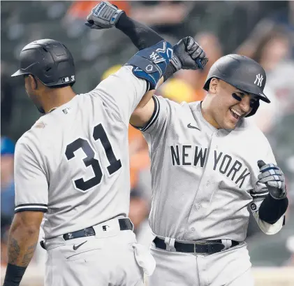  ?? NICK WASS/AP ?? The Yankees’ Jose Trevino, right, celebrates his three-run home run with teammate Aaron Hicks in the fourth inning of Monday’s game against the Orioles in Baltimore. The game wasn’t over in time for this edition. Go to courant.com/sports for the result and story.
