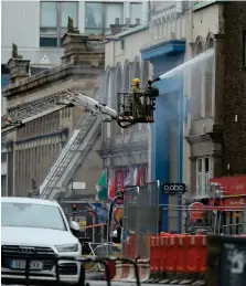  ??  ?? The O2 ABC, one of the best-known venues in Glasgow with its prime spot among popular bars and clubs, was critically damaged in Friday night’s fire Right: Fire still raged in the venue long after the worst of the flames at the Art School were under control