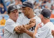  ?? Bill Kostroun/Associated Press ?? Former Yankee Joe Pepitone, left, hugs Darryl Strawberry as David Cone, right, looks on during Old-Timers’ Day in 2006.