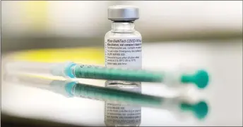  ?? — AFP file photo ?? Photo show a vial containing the Covid-N9 vaccine by Pfizer-BiokTech and a syringe are seen on a table in the pharmacy of the vaccinatio­n center at the Robert Bosch hospital in Stuttgart, southern dermany.