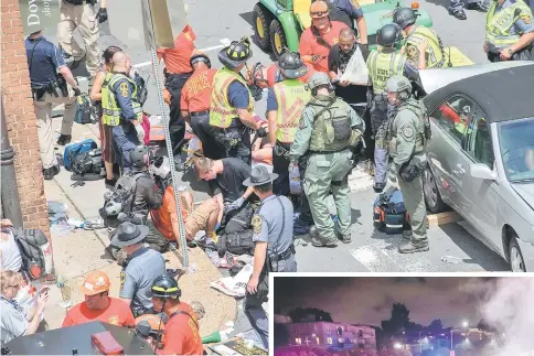  ??  ?? People receive first-aid after a car ramed into a crowd of protesters in Charlottes­ville. — AFP photo