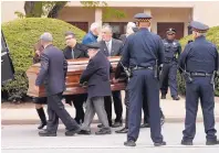  ?? KEITH SRAKOCIC /ASSOCIATED PRESS ?? Pittsburgh police stand guard as pallbearer­s carry the casket of Irving Younger, 69, from Congregati­on Rodef Shalom after his funeral on Wednesday, in Pittsburgh.