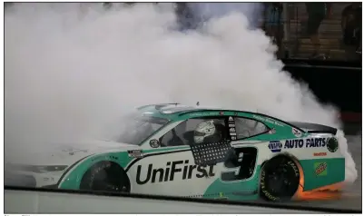  ?? (AP/Mark Humphrey) ?? Chase Elliott performs a victory burnout on the frontstret­ch at Bristol (Tenn.) Motor Speedway after winning the NASCAR All-Star Race on Wednesday night. Elliott, whose father Bill Elliott won the event in 1986, won the race for the first time.