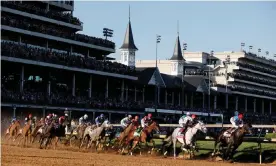  ?? Photograph: Sarah Stier/Getty Images ?? Medina Spirit leads the field around the first turn during the 147th running of the Kentucky Derby at Churchill Downs in May 2021.