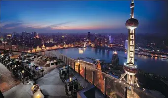  ?? PROVIDED TO CHINA DAILY ?? The Ritz-Carlton Shanghai, Pudong provides views of the Oriental Pearl Tower and the Bund, signature Shanghai attraction­s on the Huangpu River.