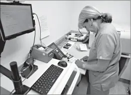  ?? Associated Press ?? ■ Stephanie Richurk, a nurse at the University of Pittsburgh Medical Center, sorts blood samples collected from participan­ts in the “All of Us” research program. The National Institutes of Health announced on Tuesday that it will open nationwide...