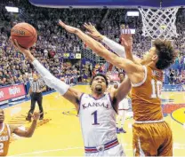  ?? Charlie Riedel / Associated Press ?? Texas forward Jaxson Hayes (10) makes it tough on Kansas forward Dedric Lawson, who goes up for a shot in the first half.