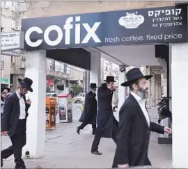  ?? Kate Shuttlewor­th
For The Times ?? THE ARRIVAL of Cofix stores in Bnei Brak has led rivals to lower prices for coffee, giving rise to a fast-food culture that has incurred religious leaders’ wrath.