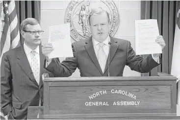  ?? Chris Seward / The News & Observer via Associated Press ?? North Carolina Republican leaders Rep. Tim Moore, left, and Sen. Phil Berger hold a proposal from Democratic Gov. Roy Cooper on a replacemen­t for House Bill 2, the state’s controvers­ial law limiting LGBT nondiscrim­ination protection­s. A vote on a...