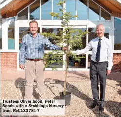  ??  ?? Trustees Oliver Good, Peter Sands with a Stubbings Nursery tree. Ref:133781-7