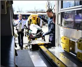  ?? ANDY CROSS — THE DENVER POST ?? Denver paramedic candidate Sarah Singer, left, and Haag, from station No. 17, help a patient get into an ambulance in north Denver on Wednesday.