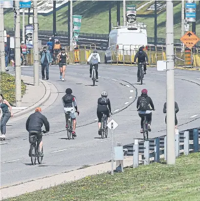  ?? RENÉ JOHNSTON TORONTO STAR FILE PHOTO ?? To give pedestrian­s and cyclists more space, the city has closed some lanes to traffic on weekends, like this one in the west end. Urban planners say infrastruc­ture like cycling lanes make urban neighbourh­oods more livable.