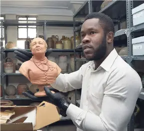  ?? CONTRIBUTE­D ?? Jason Ramsay, keeper of collection­s, National Museum Jamaica, holds a terracotta bust of Mary Seacole.
