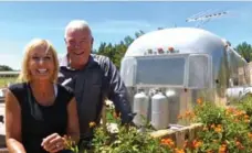  ?? LINDA BARNARD ?? Mark and Carrie Schnepf, owners of Schnept Farms, with one of the vintage Airstream trailers they rent to guests, starting at $125 a night.