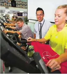  ?? Abdel-Krim Kallouche/Gulf News ?? For a noble cause Teacher David Wright (centre) and Ellie Wade with students during the ‘Cycle to South Africa’ challenge at the Dubai British School in The Springs.