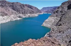  ?? AP FILE PHOTO ?? The low level of the water line is evident on the banks of the Colorado River in May in Hoover Dam, Ariz. States in the river’s lower basin, including Arizona, have pulled millions more acre-feet from the river than they are due.