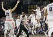  ?? DAVID J. PHILLIP — THE ASSOCIATED PRESS ?? Gonzaga players celebrate after the semifinals of the Final Four NCAA college basketball tournament against South Carolina, Saturday in Glendale, Ariz. Gonzaga won 77-73.