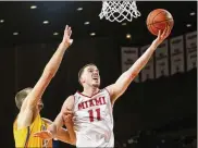  ?? CONTRIBUTE­D ?? Miami’s Logan McLane goes up to score Friday against Toledo at Millett Hall. Miami set a season low with four 3-pointers as Toledo won 73-67.