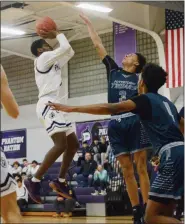  ?? OWEN MCCUE - MEDIANEWS GROUP ?? Phoenixvil­le’s Steven Hamilton, center, shoots over Pottstown’s Darius Smallwood on Thursday.