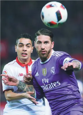  ?? ANGEL FERNANDEZ / AP ?? Real Madrid’s Sergio Ramos (right) and Sevilla’s Ben Yedder tussle for the ball during their Spanish King’s Cup tie at Ramon Sanchez Pizjuan Stadium, in Seville on Thursday.