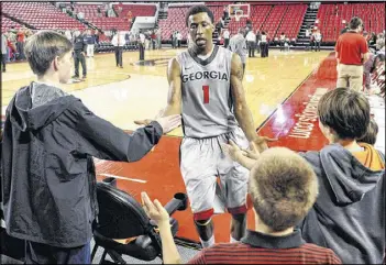  ?? AJ REYNOLDS / ATHENS BANNER-HERALD ?? Caldwell-Pope, greeting fans after Georgia’s overtime win against South Carolina in Athens in February, has been the Bulldogs’ dominant player by far this season. Named the SEC Player of the Year, the sophomore is a prime candidate to be lured away...