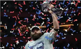  ??  ?? Julian Edelman lifts the Vince Lombardi trophy after Super Bowl 53, when the wide receiver was named MVP. Photograph: Timothy A Clary/AFP/Getty Images