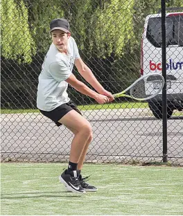  ?? ?? Warragul Purple’s Miller Ireland prepares to hit a backhand in the singles.