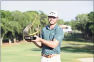  ?? Julio Aguilar / Getty Images ?? Sam Burns celebrates with the trophy after winning the Valspar Championsh­ip on the Copperhead Course at Innisbrook Resort on Sunday in Palm Harbor, Fla.