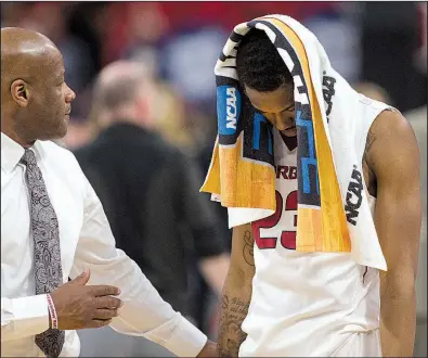  ?? NWA Democrat-Gazette/BEN GOFF ?? Arkansas sophomore C.J. Jones (right) and Razorbacks Coach Mike Anderson walk off the court Friday after the Hogs’ loss to Butler in the first round of the NCAA Tournament at Detroit. See more photos at arkansason­line.com/galleries