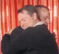  ?? PHOTO: GUY WILLIAMS ?? Changing of the guard . . . Queenstown Lakes District Councillor Glyn Lewers embraces AJ Mason after a coin toss to decide who would take the final seat around the council table a year ago today.