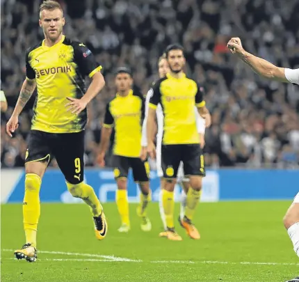  ?? Picture: Getty Images. ?? Harry Kane fires in his second and Tottenham’s third goal against Dortmund.