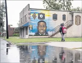  ?? NICOLE CRAINE — THE NEW YORK TIMES ?? A mural of Ahmaud Arbery in Brunswick, Ga., where three White men were on trial for his killing this month. The concurrent trials here and in Kenosha, Wis., expose deep fault lines in the legal and moral concept of self-defense, a doctrine that is ill equipped to handle an era of expanded gun rights.