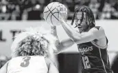  ?? Vasha Hunt / Associated Press ?? UH guard Tramon Mark, right, is out for the “foreseeabl­e future” with a left shoulder injury.