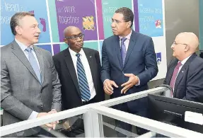  ?? RUDOLPH BROWN/PHOTOGRAPH­ER ?? Prime Minister Andrew Holness (second right) chats with (from left) Joseph Arena, firm controller of KPMG LLP; Donald Barnett, partner, outsourcin­g of KPMG in Jamaica; and R. Tarun Handa, managing partner of KPMG in Jamaica. The occasion was the launch of KPMG’s new nearshore shared services facility, Jamaica Extended Support Services, in downtown Kingston yesterday.