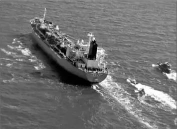  ?? TASNIM NEWS AGENCY VIA AP ?? In this Jan. 4 file photo released by Tasnim News Agency, a seized South Korean-flagged tanker is escorted by Iranian Revolution­ary Guard boats on the Persian Gulf.