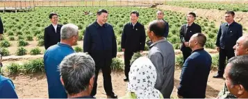  ?? — Xinhua ?? Helping hand: President Xi Jinping (second from left) has a complete portfolio of poverty relief plans, despite the sudden onslaught of Covid-19.