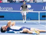  ?? FRANK FRANKLIN II/AP ?? Stefanos Tsitsipas, top, of Greece, walks to the net after losing to Carlos Alcaraz, of Spain, during the third round of the US Open on Friday in New York.