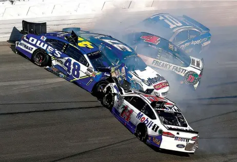  ?? Associated Press ?? Jimmie Johnson (48), Clint Bowyer (14), Kevin Harvick (4) and Danica Patrick (10) crash during the Daytona 500 auto race Sunday at Daytona Internatio­nal Speedway in Daytona Beach, Fla. Kurt Busch won Sunday’s season-opening race.