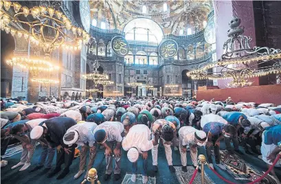  ?? BURAK KARA GETTY IMAGES ?? Thousands took part in Friday prayers at Istanbul’s Byzantine-era Hagia Sophia, which has existed as a museum since 1934.