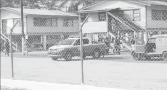  ??  ?? Police and members of the SWAT team surround the house in which two suspects were holding an individual during Operation Assurance 2 at Timehri on Friday.