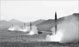  ?? Korean Central News Agency via AFP/Getty Images ?? NORTH KOREA recently launched four missiles that traveled 620 miles before landing in the Sea of Japan, heightenin­g concerns about an EMP attack.