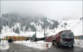  ?? ANI ?? Trucks move on a snow-covered Srinagar-jammu National highway at Qazigund in Anantnag on Sunday.